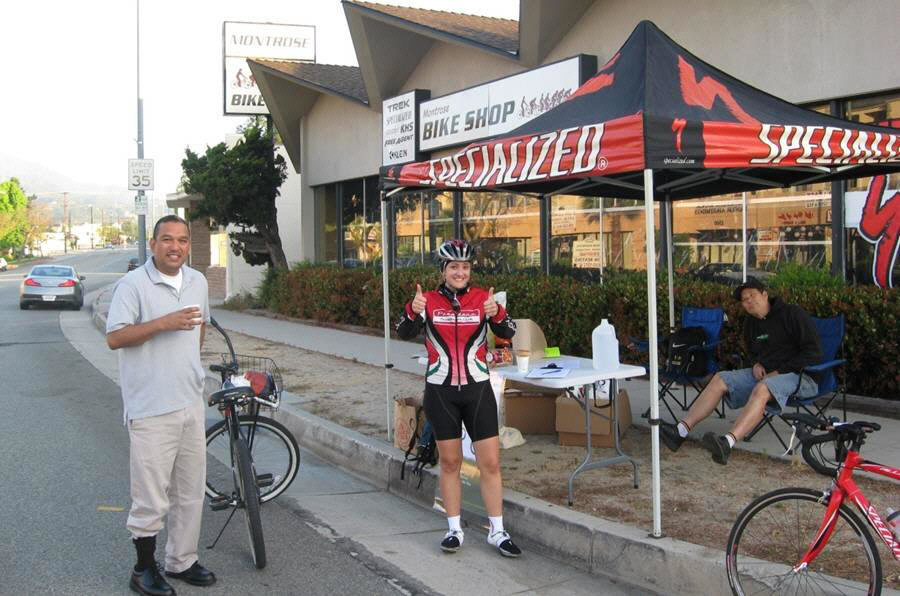 Participants of the Bike to Work day make a pit stop at the Montrose Bike Shop, one of the community sponsors of the event.